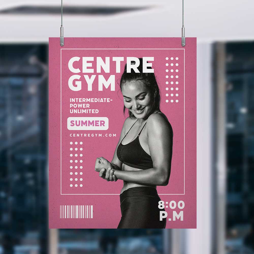 Image shows a panel sign being hung via two cables and large panel grippers from the top left and right corners. Sign shows a woman flexing her bicep and reads 'centre gym intermediate-power unlimited summer centregym.com 8:00 p.m